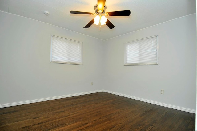 spare room featuring dark wood-type flooring and ceiling fan