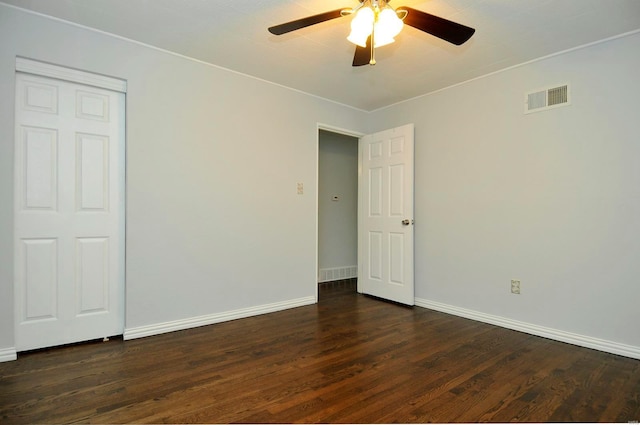 unfurnished room featuring ceiling fan and dark hardwood / wood-style flooring