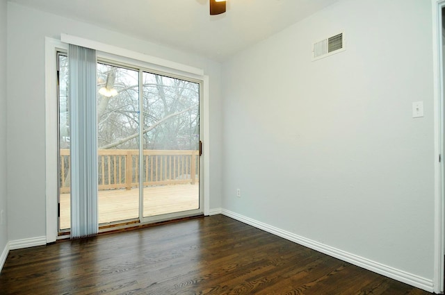 empty room with dark hardwood / wood-style floors and ceiling fan