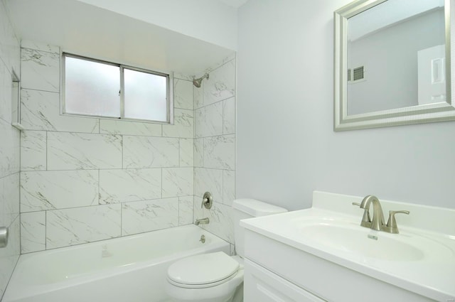 full bathroom with vanity, tiled shower / bath combo, and toilet