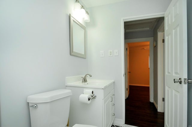 bathroom with vanity, hardwood / wood-style floors, and toilet