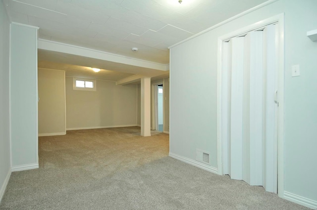 basement featuring light colored carpet