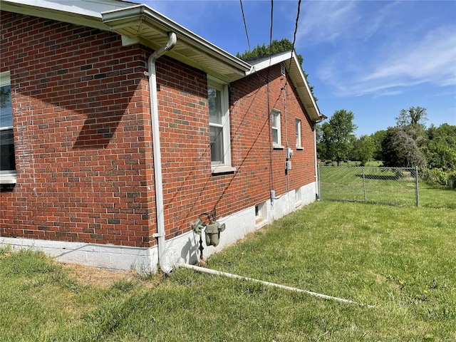 view of side of home featuring a lawn