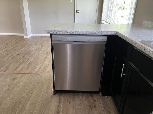 kitchen with dishwasher, kitchen peninsula, and light hardwood / wood-style flooring