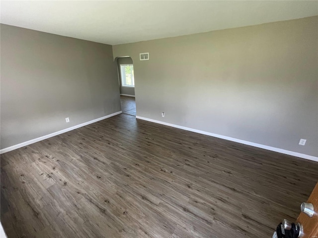 empty room with dark wood-type flooring