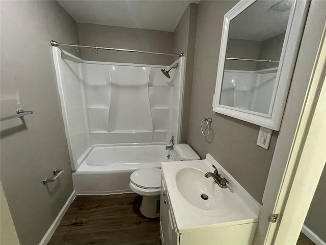 full bathroom featuring shower / washtub combination, hardwood / wood-style floors, vanity, and toilet