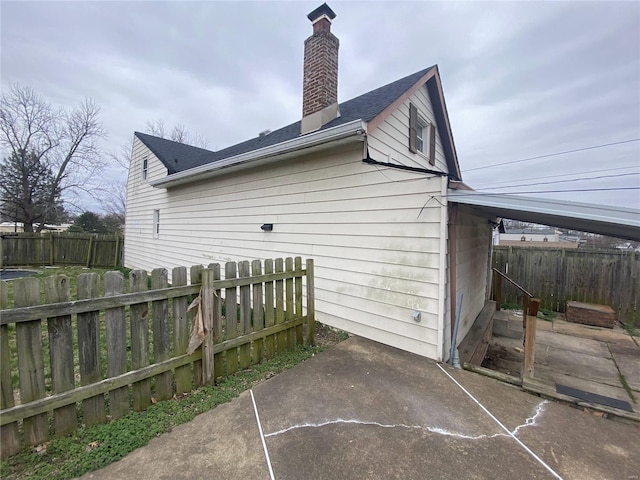 view of side of property featuring a patio area