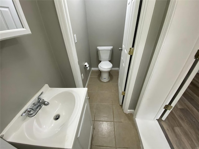 bathroom featuring vanity, tile patterned floors, and toilet