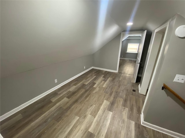 bonus room featuring lofted ceiling and wood-type flooring