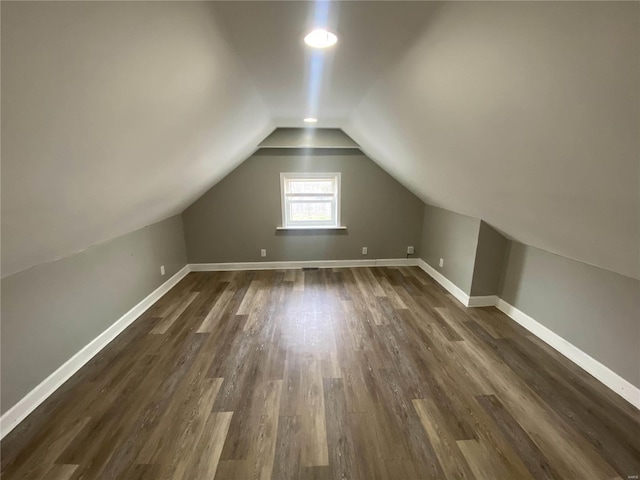 bonus room featuring lofted ceiling and dark hardwood / wood-style flooring