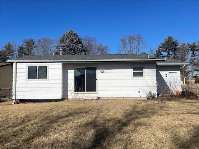 rear view of property with a yard