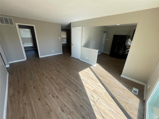 unfurnished living room with dark hardwood / wood-style flooring