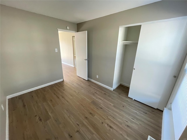 unfurnished bedroom with a closet and light hardwood / wood-style flooring