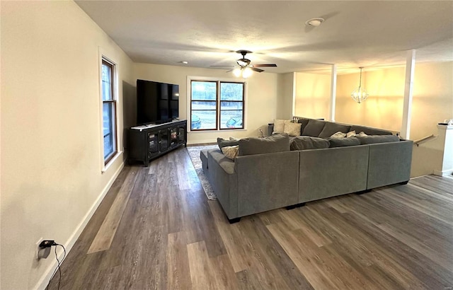 living room with dark hardwood / wood-style flooring and ceiling fan