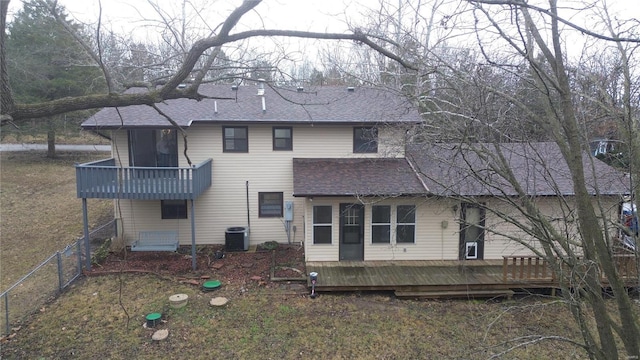 rear view of house with a wooden deck and a balcony