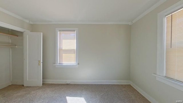 unfurnished bedroom with ornamental molding, carpet, a closet, and baseboards