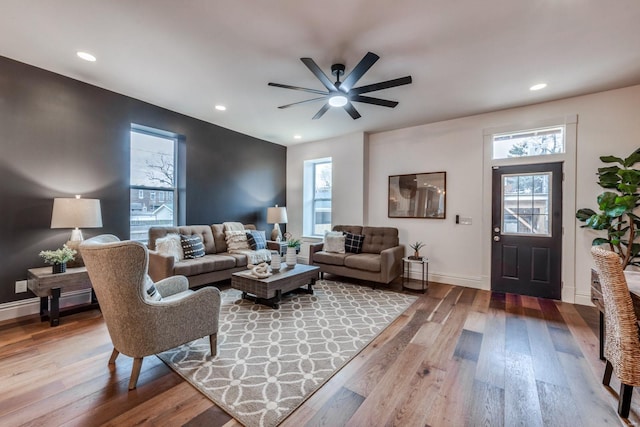 living room with hardwood / wood-style flooring, a healthy amount of sunlight, and ceiling fan