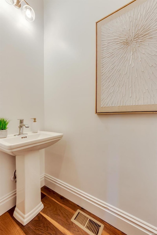 bathroom featuring wood-type flooring and sink