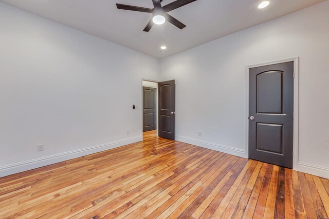 unfurnished bedroom with ceiling fan and light wood-type flooring