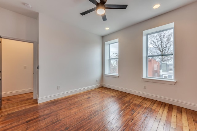 empty room featuring dark wood-type flooring and ceiling fan