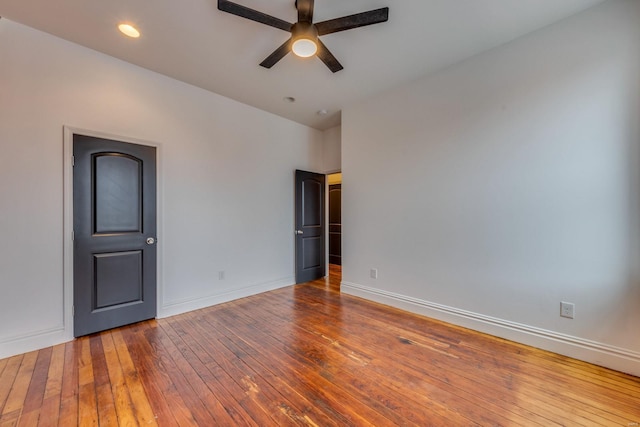 spare room with wood-type flooring and ceiling fan