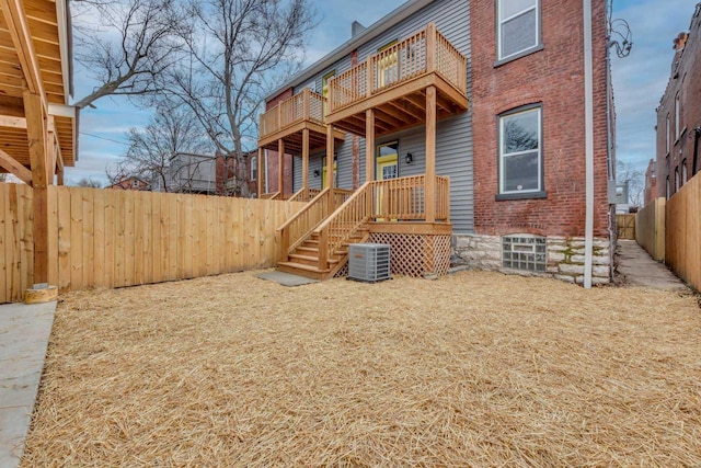 rear view of property with a balcony and central air condition unit