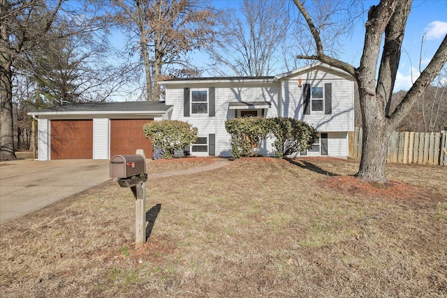 bi-level home with a garage and a front lawn