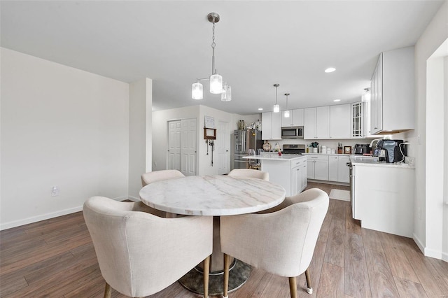 dining space with dark hardwood / wood-style flooring