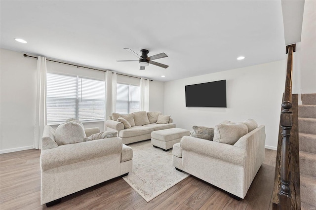 living room featuring ceiling fan and wood-type flooring