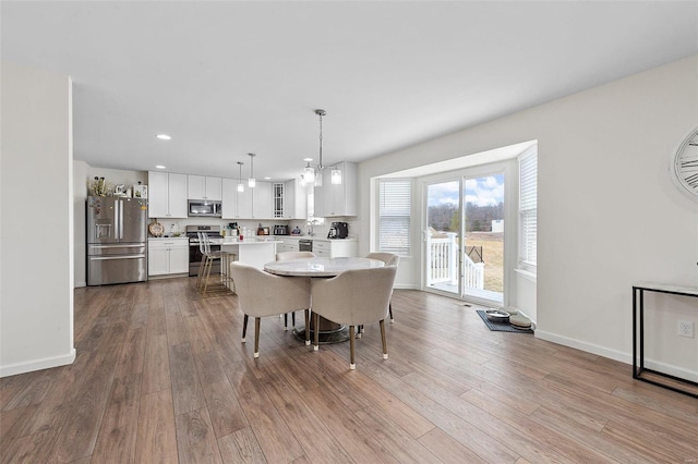 dining space with light wood-type flooring