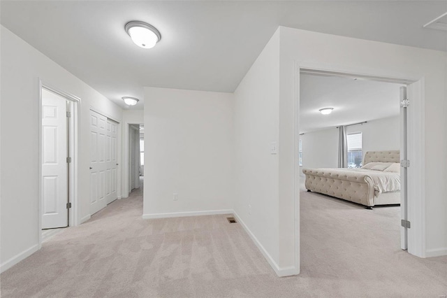 hallway featuring light carpet