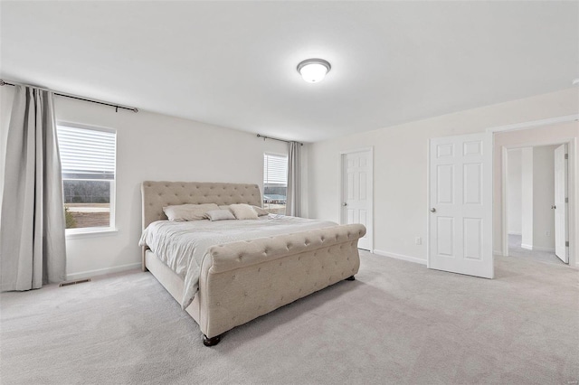 bedroom featuring light carpet