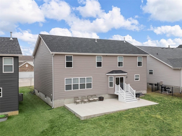 rear view of property with a yard and a patio area