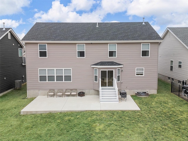 rear view of property featuring a yard, a patio area, and central air condition unit