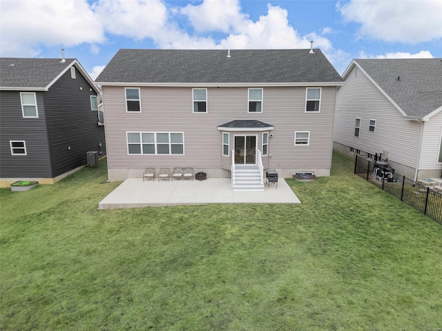 rear view of property with a patio, a yard, and central AC unit