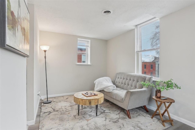 living area with a textured ceiling