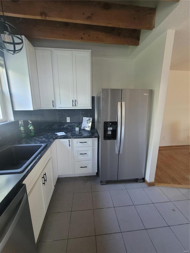 kitchen with white cabinetry, tile patterned floors, appliances with stainless steel finishes, and sink