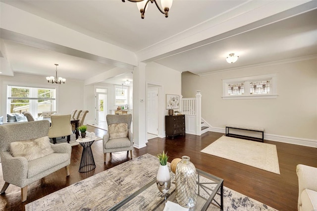 living room featuring beamed ceiling, crown molding, dark wood-type flooring, and a notable chandelier