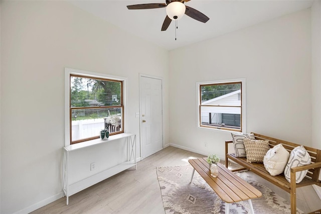 living area featuring ceiling fan and light hardwood / wood-style flooring