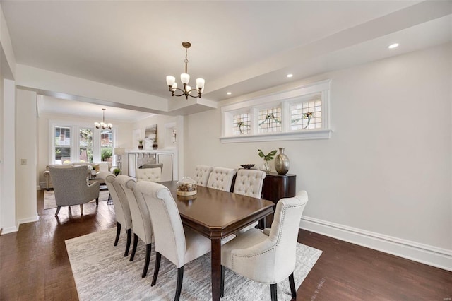 dining area featuring dark hardwood / wood-style flooring and a chandelier