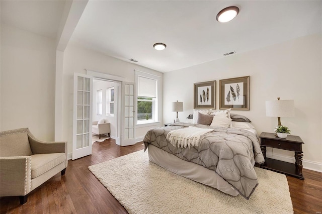 bedroom featuring dark hardwood / wood-style floors and french doors