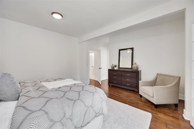 bedroom with dark wood-type flooring