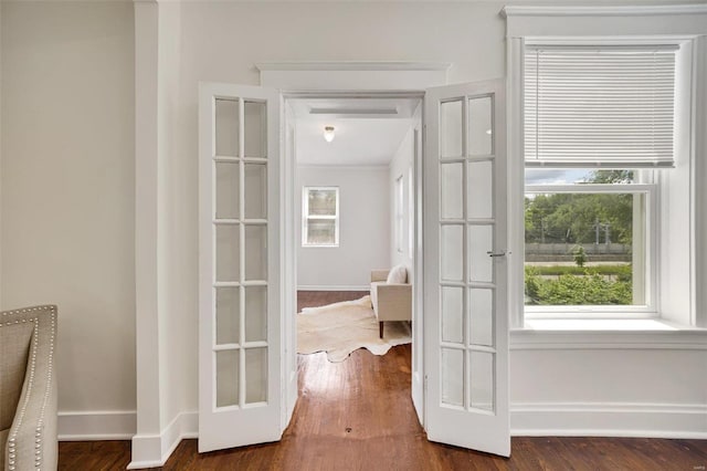 doorway to outside with dark hardwood / wood-style flooring and french doors