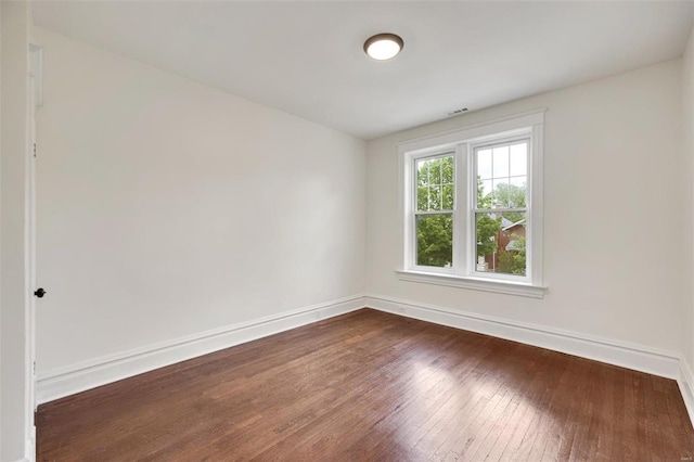 unfurnished room with dark hardwood / wood-style floors