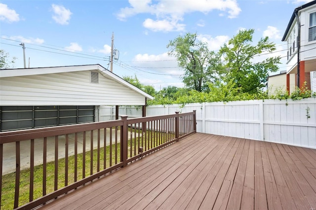 wooden deck featuring a lawn