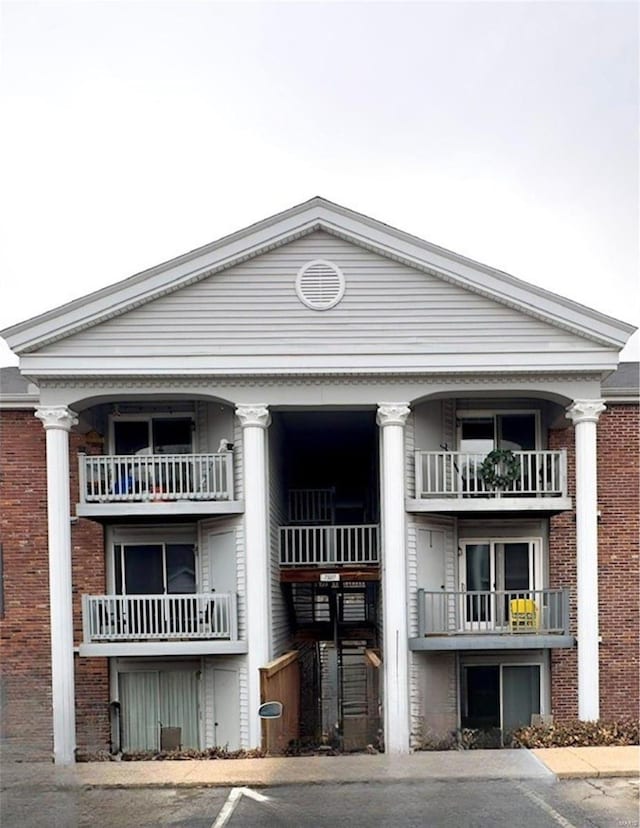 view of property featuring uncovered parking