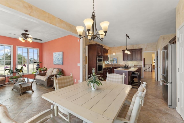 dining space featuring light tile patterned floors and ceiling fan with notable chandelier