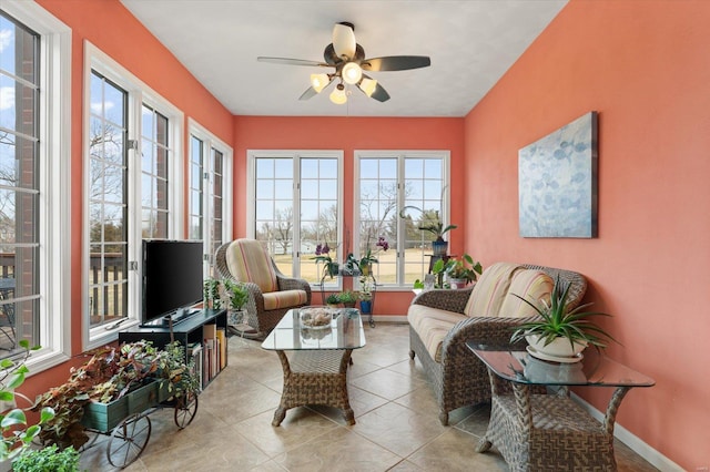 sunroom / solarium featuring ceiling fan