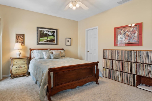 bedroom with a ceiling fan, visible vents, and light colored carpet