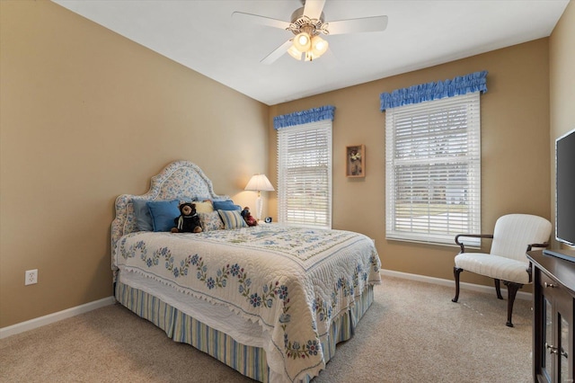 bedroom featuring light colored carpet, ceiling fan, baseboards, and multiple windows